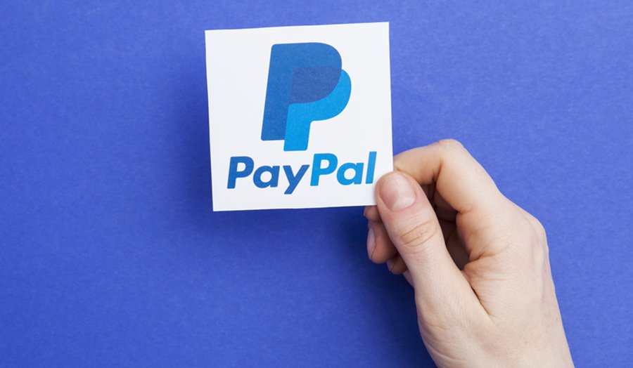 Hand holding PayPal logo