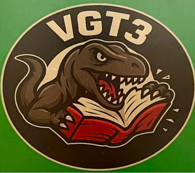 Imagem mostra o logotipo de uma unidade industrial chamada VGT3. O logo mostra um dinossauro destruindo um livro.